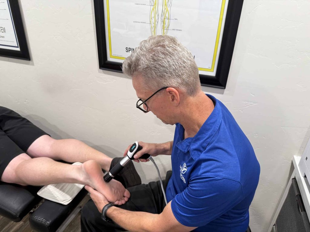 Doctor Cox working on patients foot